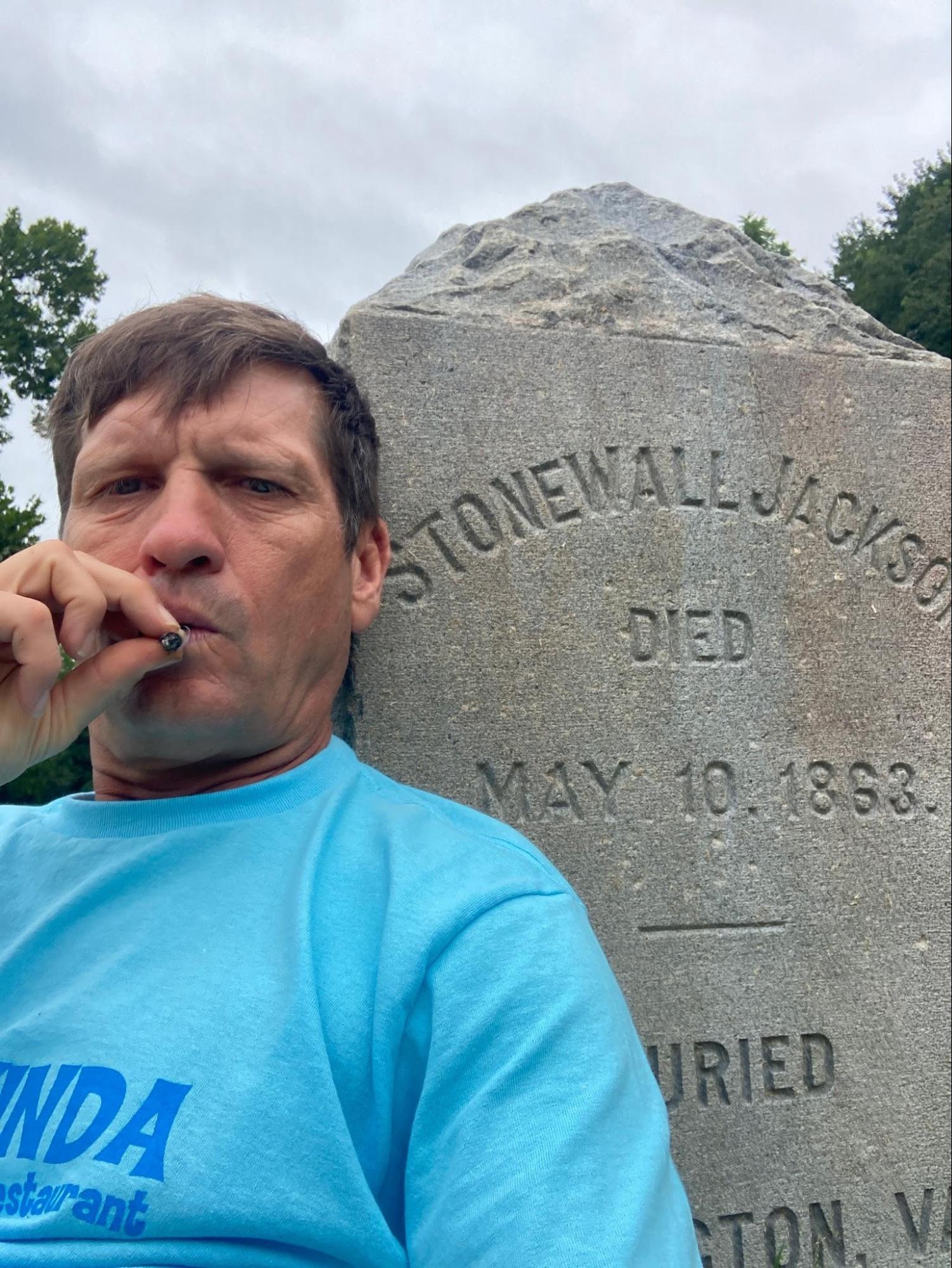 The Author smoking a joint on Stonewall Jackson’s gravestone. Gettysburg, Pennsylvania.
